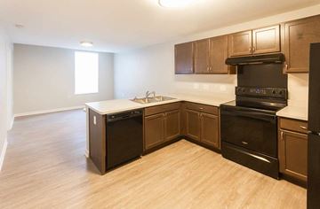 Columbus apartment for rent - A kitchen with wooden cabinets and a black oven.