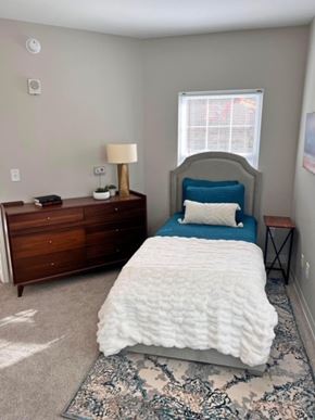 Atlanta apartment for rent - A bedroom with a bed, nightstand, and lamp.