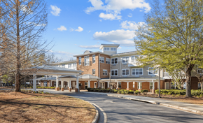 Atlanta apartment for rent - A large building with a curved driveway in front.