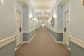 Lithonia apartment for rent - A long hallway with white doors and a carpeted floor.