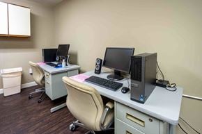 Cincinnati apartment for rent - Two computers on desks in a room.