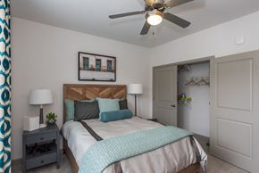 Williamsburg apartment for rent - a bedroom with a bed and a ceiling fan at The Whitworth, Williamsburg, 23185