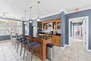 Virginia Beach apartment for rent - a communal kitchen with a bar and chairs in a lobby at Saltmeadow Bay, Virginia Beach, 23451
