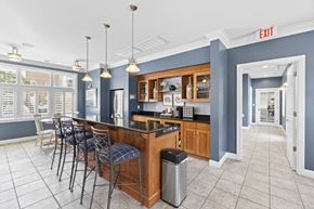 Virginia Beach apartment for rent - a communal kitchen with a bar and chairs in a lobby at Saltmeadow Bay, Virginia Beach, 23451