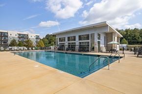 Asheville apartment for rent - A large swimming pool in front of a building.