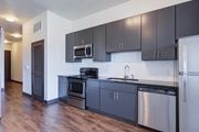 Chattanooga apartment for rent - A kitchen with black cabinets and stainless steel appliances.