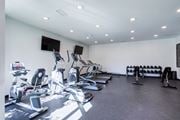 Chattanooga apartment for rent - A gym with a variety of exercise equipment including treadmills, stationary bikes, and weight racks.