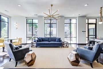 Chattanooga apartment for rent - A living room with a blue couch and a large window.