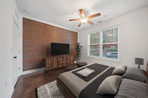 Asheville apartment for rent - A bedroom with a bed, a tv, and a ceiling fan at Skyloft in Asheville, North Carolina 28803