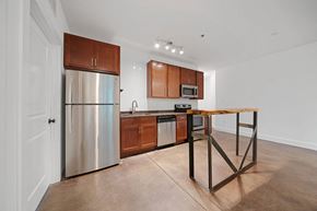Asheville apartment for rent - A kitchen with a wooden table and stainless steel appliances at Skyloft in Asheville, 28803