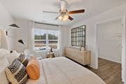 Oak Ridge apartment for rent - a bedroom with a large bed and a ceiling fan at Summit Place Apartments, Tennessee