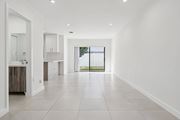 Miami Gardens apartment for rent - A spacious, empty room with white walls and tile flooring.at The Villages at Miami Gardens, Miami Gardens Florida