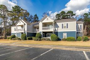 Macon apartment for rent - A large two-story apartment building with a parking lot in front.