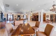 Warner Robins apartment for rent - A large, well-lit dining room with a wooden table and chairs.