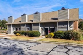 Augusta apartment for rent - A building with a grey facade and a brown roof.
