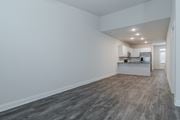 Acworth townhouse for rent - A kitchen with white cabinets and a refrigerator is visible in the background.