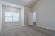 Acworth townhouse for rent - A room with a carpeted floor, a door, and a window with blinds.