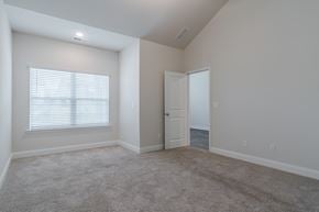 Acworth townhouse for rent - A room with a carpeted floor, a door, and a window with blinds.