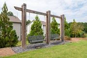 Acworth townhouse for rent - A wooden swing set in a grassy area with a house in the background.