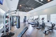 Commerce apartment for rent - A gym with a variety of equipment including treadmills, weights, and a punching bag.