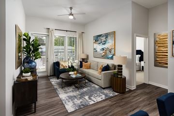 Henrico apartment for rent - A living room with a couch, a coffee table, and a painting on the wall.