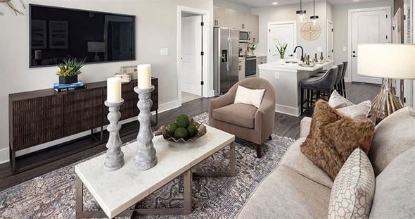 Lawrenceville apartment for rent - a living room with a couch and a table at The Flats at Southlawn Apartments, Lawrenceville, 30046