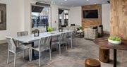 Lawrenceville apartment for rent - a dining room with tables and chairs and a television at The Flats at Southlawn Apartments, Lawrenceville, GA