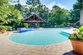 Athens apartment for rent - A pool surrounded by trees and a pavilion.