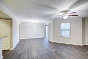 Athens apartment for rent - A room with a ceiling fan and a window with blinds.