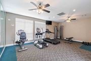 Warner Robins apartment for rent - A home gym with a variety of equipment including a treadmill, stationary bike, and weights.