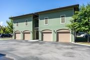 Hixson apartment for rent - A two-story building with a green exterior and three garage doors.