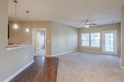 Hixson apartment for rent - A spacious room with a ceiling fan and a large window.