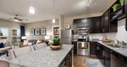 Hixson apartment for rent - a kitchen and living room with a granite counter top at Integra Vista Apartments, Hixson, 37343