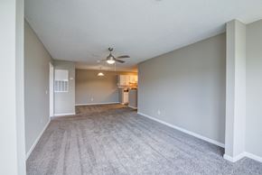 Martinez apartment for rent - A spacious room with a ceiling fan and carpeted floor.