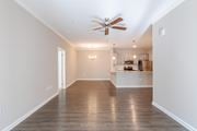 Hixson apartment for rent - A spacious room with a ceiling fan and hardwood floors.