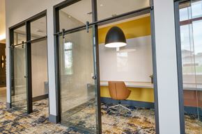 Prospect apartment for rent - a conference room with a yellow accent wall and glass sliding doors at Lyric at Norton Commons Apartments, Prospect, 40059