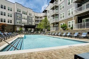 Prospect apartment for rent - A large swimming pool surrounded by apartment buildings.