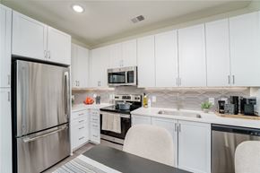 Prospect apartment for rent - a kitchen with white cabinets and stainless steel appliances at Lyric at Norton Commons Apartments, Prospect, KY