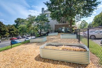 Chattanooga apartment for rent - A large, empty swimming pool sits in the middle of a gravel area.