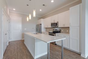 Chattanooga apartment for rent - A kitchen with white cabinets and a white island.