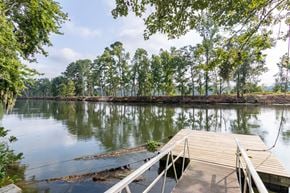 Augusta apartment for rent - A dock extends into a calm body of water with trees in the background.