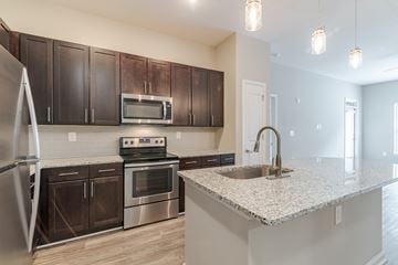 Augusta apartment for rent - A kitchen with a stove, oven, refrigerator, and microwave.