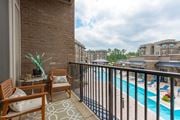 Augusta apartment for rent - a balcony with a swimming pool and a patio with chairs at Residence at Riverwatch, Augusta