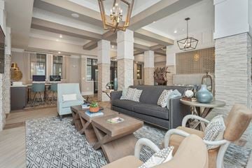 Augusta apartment for rent - a living room with couches and chairs and a table