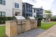 Santa Rosa Beach apartment for rent - A brick BBQ grill is in front of a white and grey apartment building.