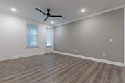 Santa Rosa Beach apartment for rent - A room with a ceiling fan and wooden flooring.