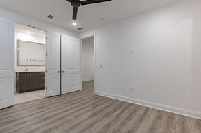 Santa Rosa Beach apartment for rent - A room with a ceiling fan and a large mirror.