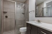 Santa Rosa Beach apartment for rent - A modern bathroom with a walk-in shower and a white toilet.