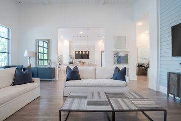 Arden apartment for rent - A modern living room with a white couch and a coffee table.