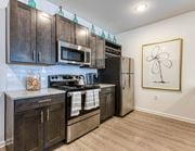 Arden apartment for rent - a kitchen with stainless steel appliances and wooden cabinets at Retreat at Arden Farms, Arden, NC
